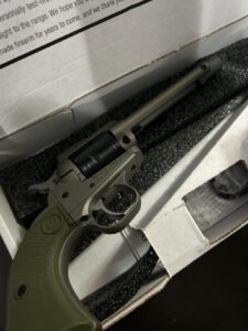 Revolver firearm in open box packaging