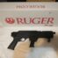 Ruger firearm on white surface near box