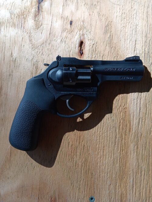 Black revolver on wooden surface