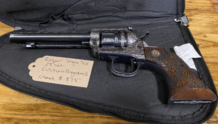 Engraved Ruger revolver with price tag in case.