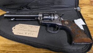 Engraved Ruger revolver with price tag on case.