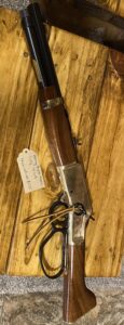 Lever-action rifle on a wooden table.