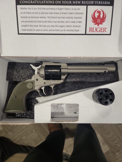 Ruger revolver and spare cylinder in box.