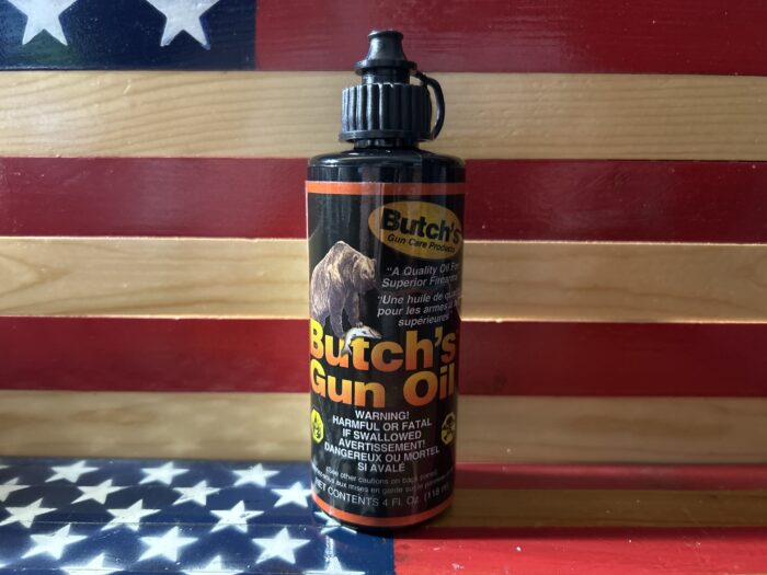 Butch's Gun Oil bottle on American flag background.