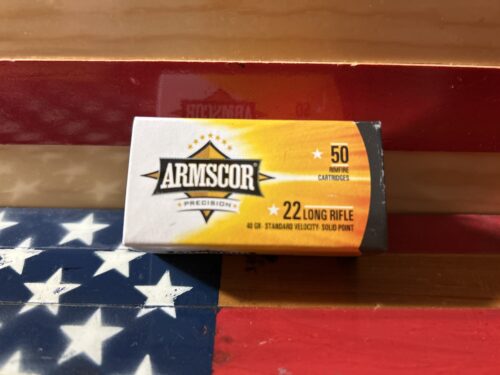 Armscor .22 rifle ammunition box, American flag background.