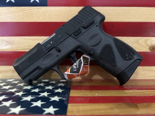 Black Taurus firearm on American flag background