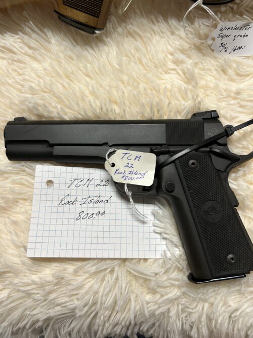 Rock Island pistol with price tag on fur surface.