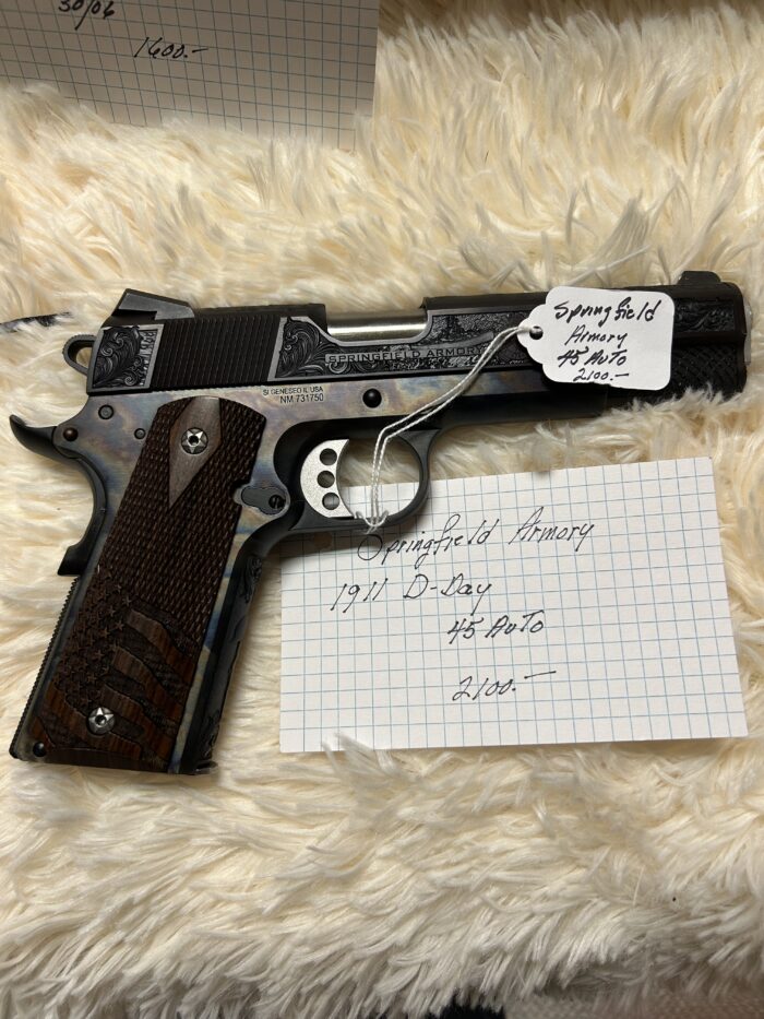 Springfield Armory 1911 pistol with handwritten label.