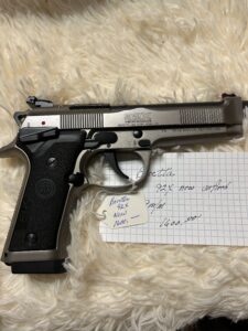 Beretta 92X pistol with price tag on notes.