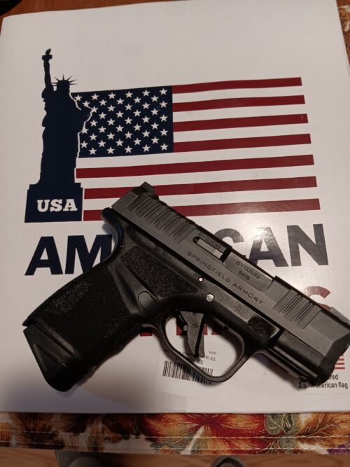 Springfield Armory handgun on American USA flag background.