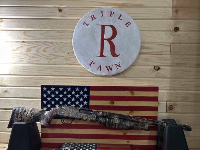 Camo shotgun displayed with American flag background