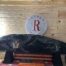 Triple R bar logo on wooden wall, rifle case.