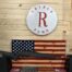 Rifle displayed with American flag backdrop.