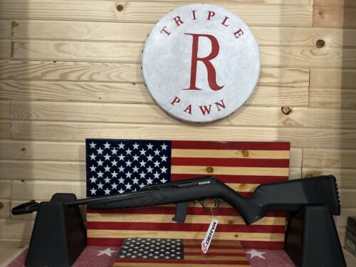 Air rifle displayed on American flag backdrop.