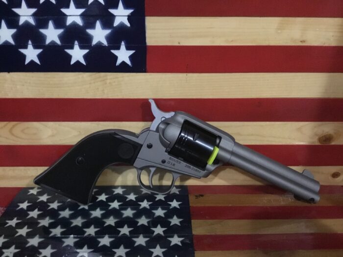 Revolver in front of American flag background.