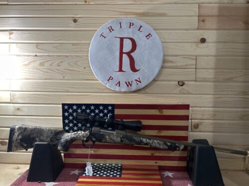 Camouflage rifle on American flag backdrop