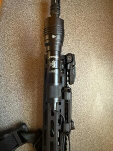 Mounted tactical flashlight on firearm rail system