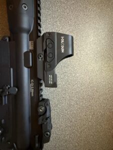 Holosun sight mounted on firearm rail system.