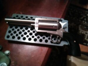 Silver revolver on a black stand