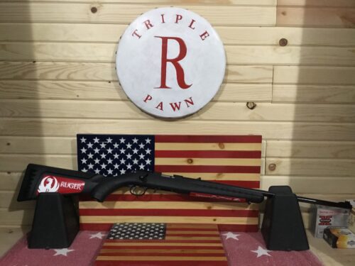 Ruger rifle displayed with American flags