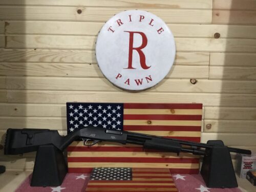 Shotgun displayed with American flags in shop.