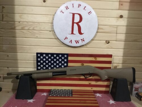 Winchester shotgun displayed on American flag backdrop.