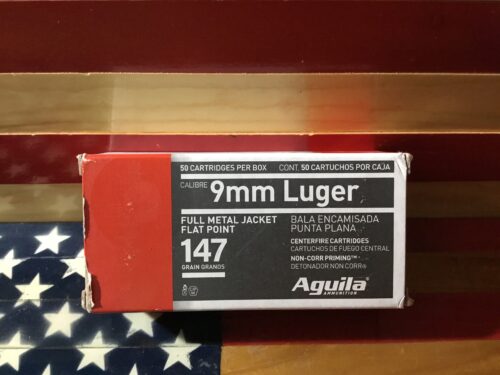 9mm Luger ammunition box on American flag.