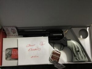 Revolver in box with instructions and lock.