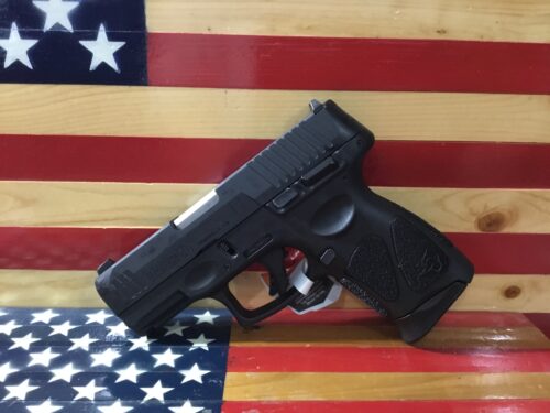 Black handgun against American flag background.