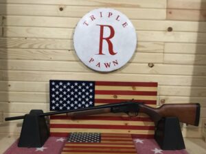 Rifle displayed against American flag backdrop.