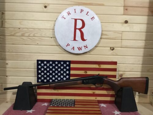 Rifle displayed against American flag backdrop.