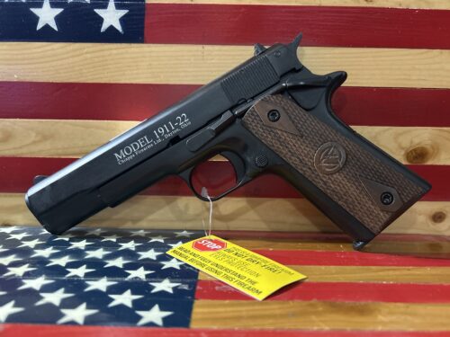 Handgun on American flag backdrop.