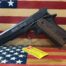 Handgun on American flag backdrop.