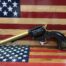 Pistol on American flag background.