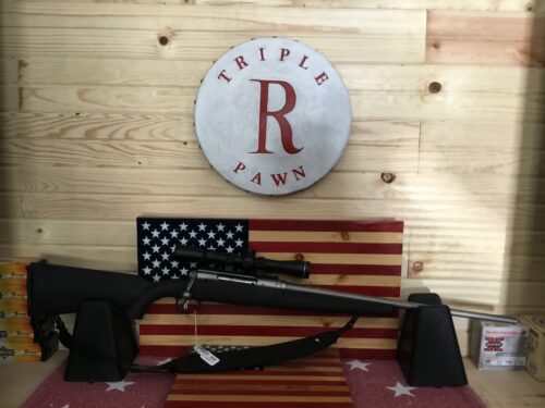 Rifle on display with American flag background.