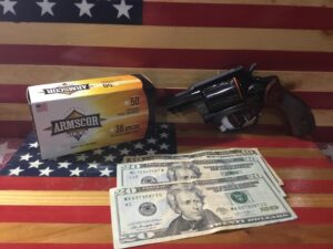 Revolver, Ammo Box, and Cash on American Flag Background