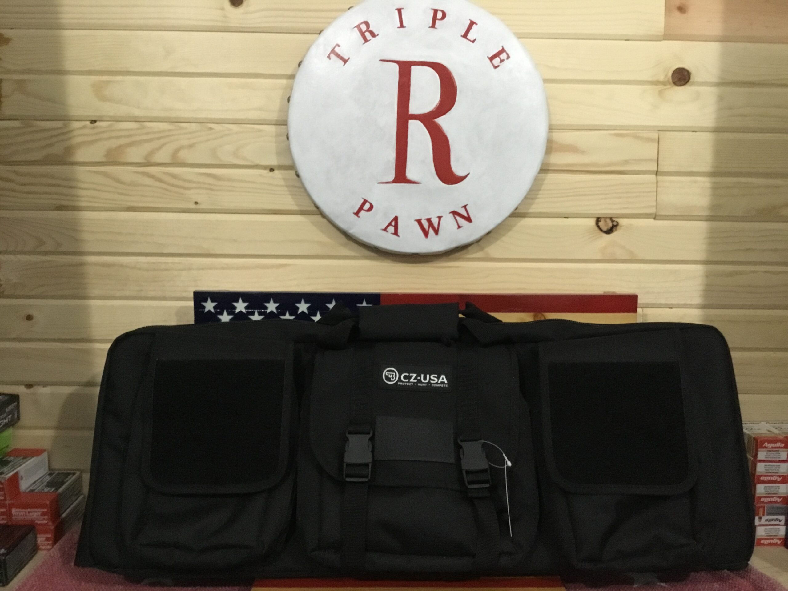 Black tactical bag on wooden background