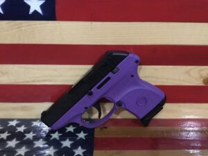 Purple handgun on an American flag background.
