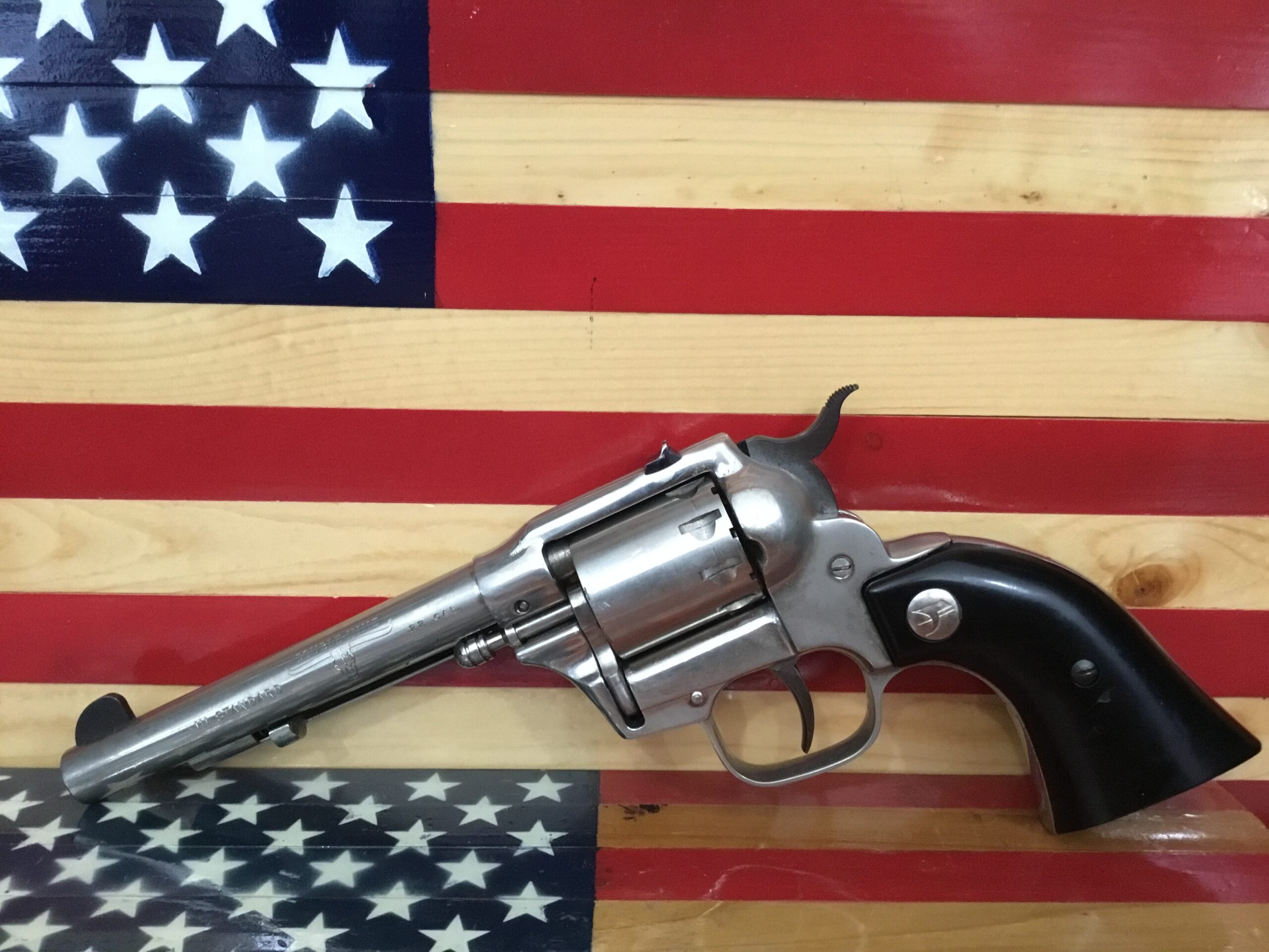 Revolver displayed on American flag background.