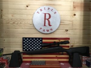Rifle displayed on American flag backdrop