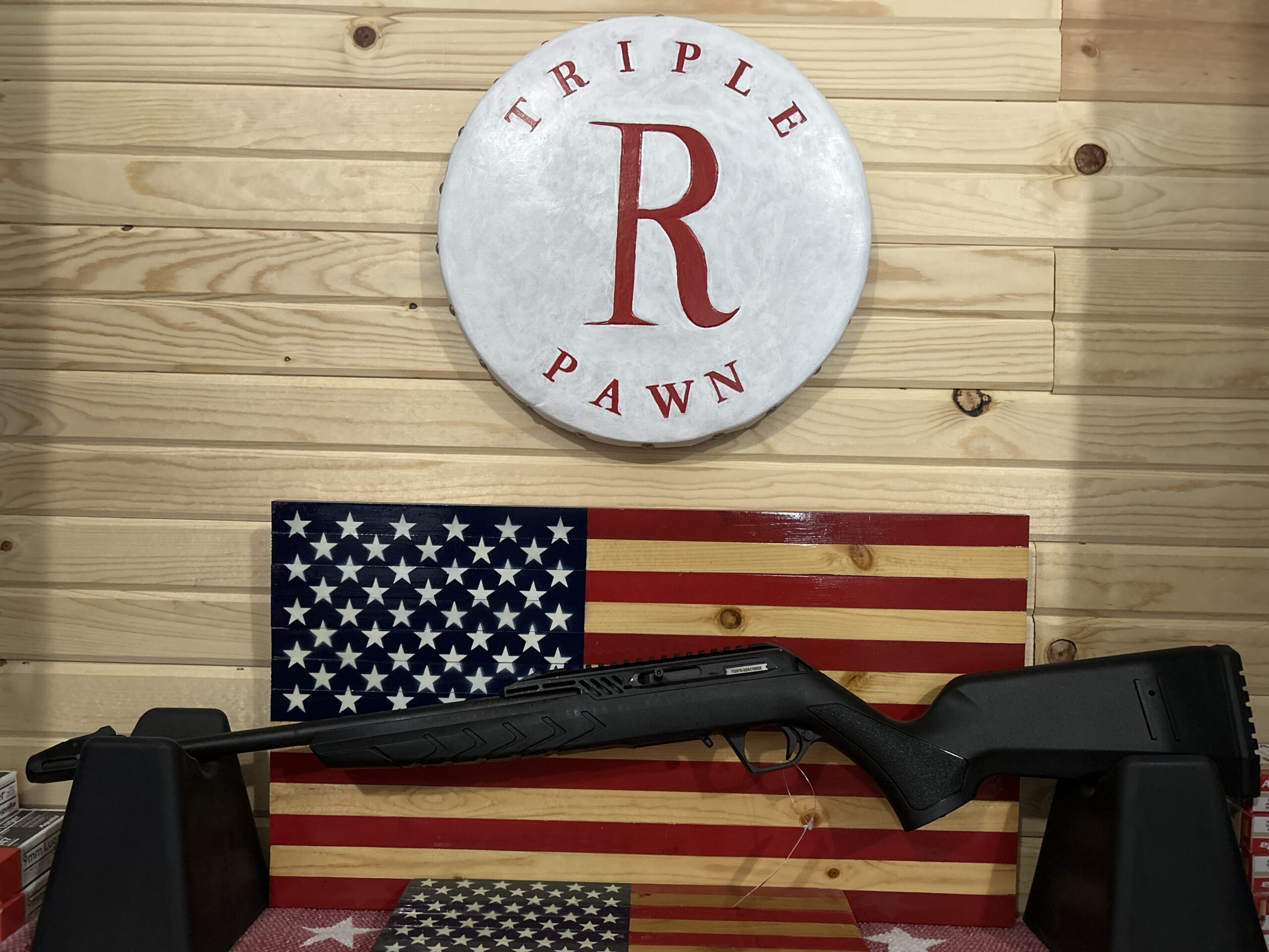 Rifle on stand with American flag background