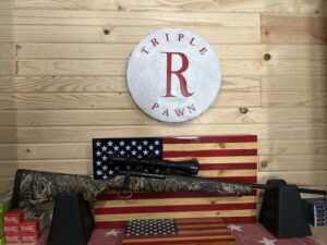 Hunting rifle displayed on American flag background.