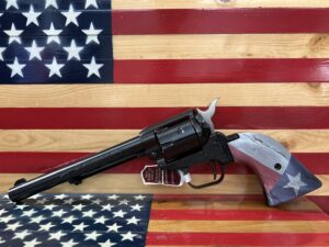 Revolver with flag design on wooden background