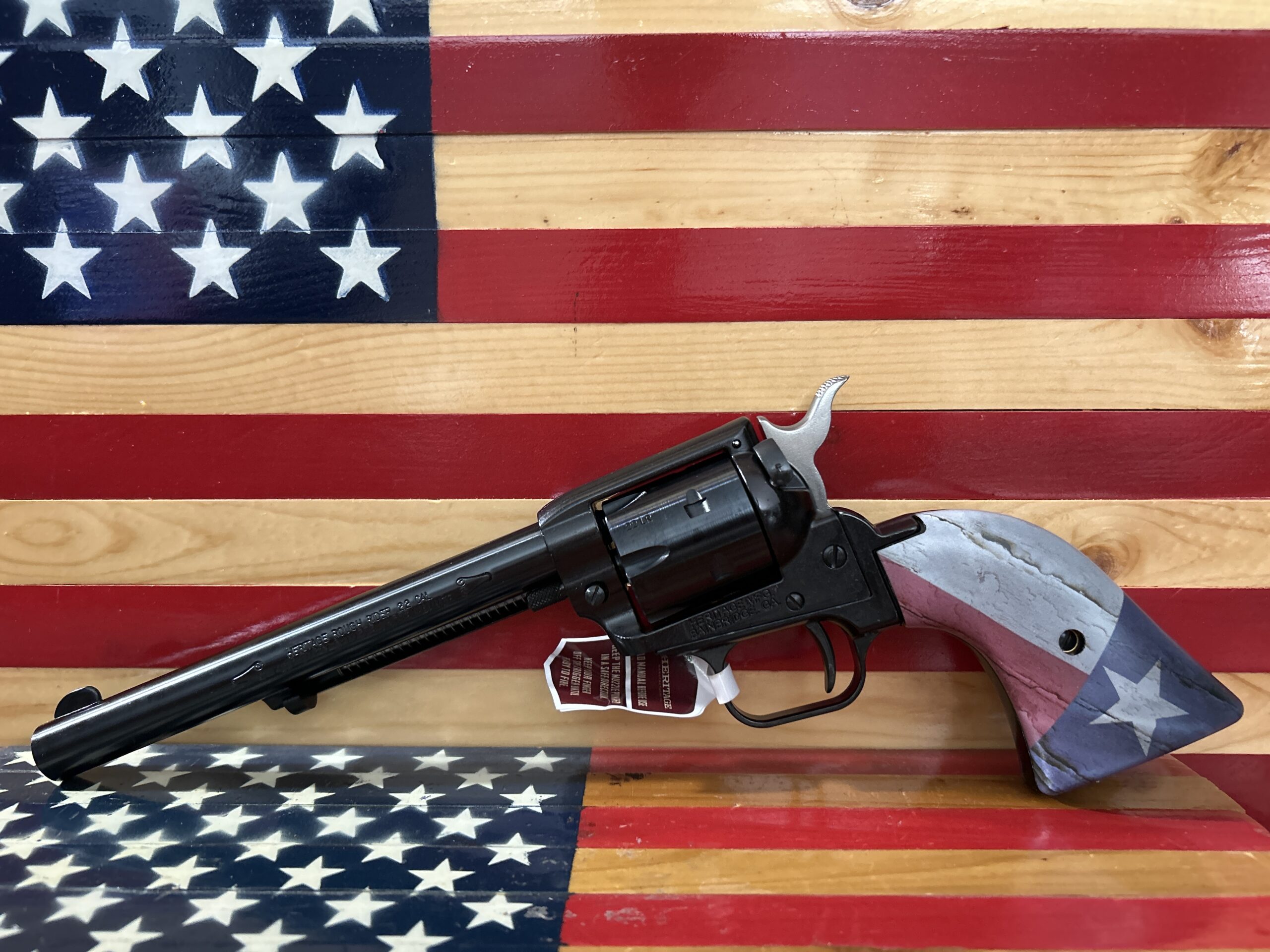 Revolver with flag design on wooden background