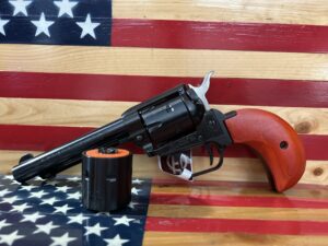 Revolver with wooden handle on American flag background.