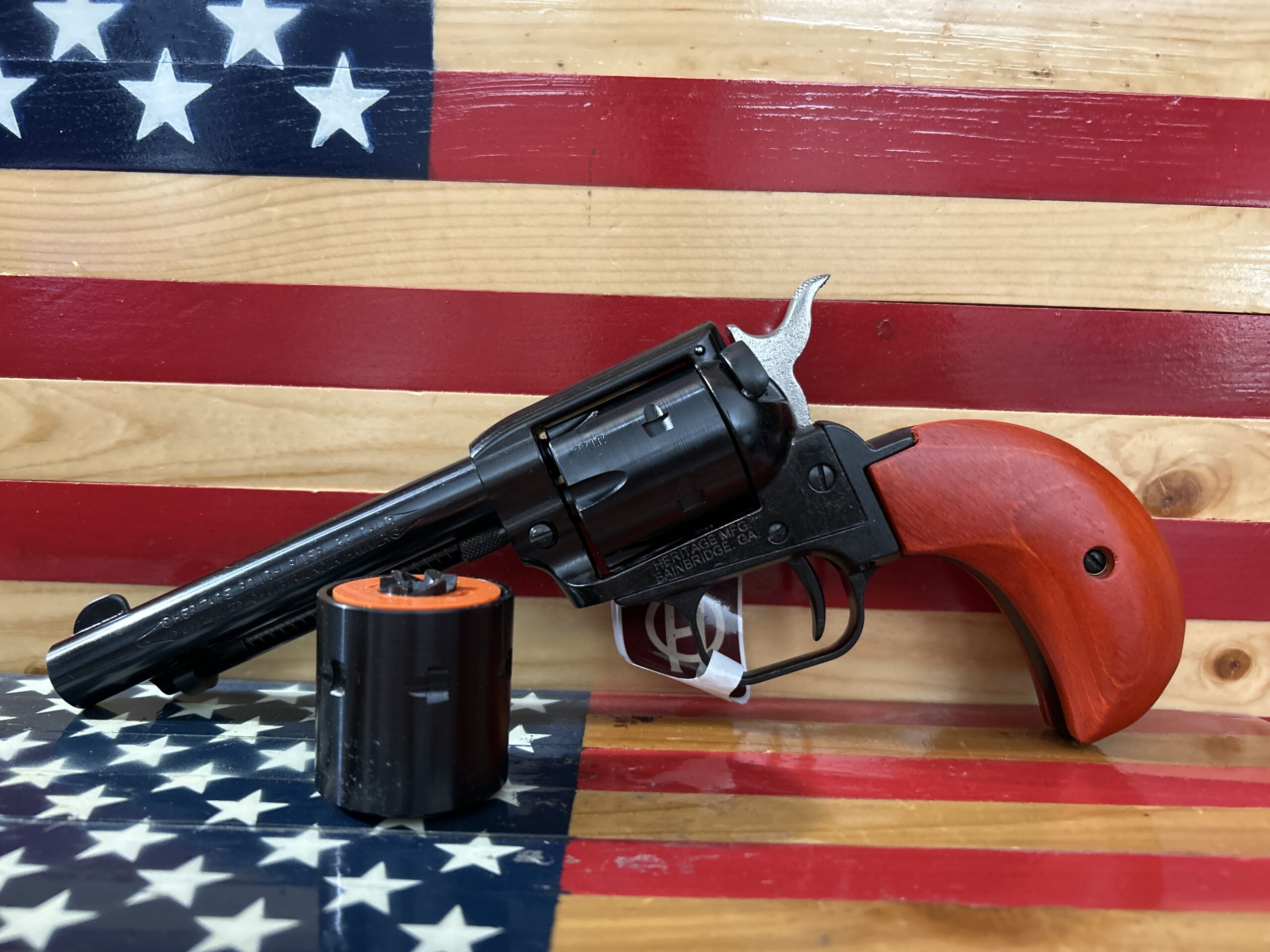 Revolver with wooden handle on American flag background.