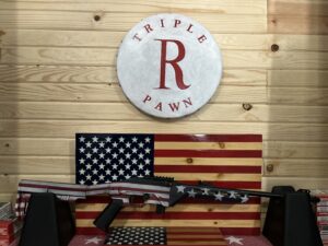 American flag-themed rifle in pawn shop display.