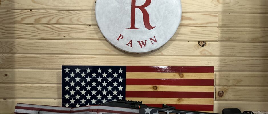 American flag-themed rifle in pawn shop display.