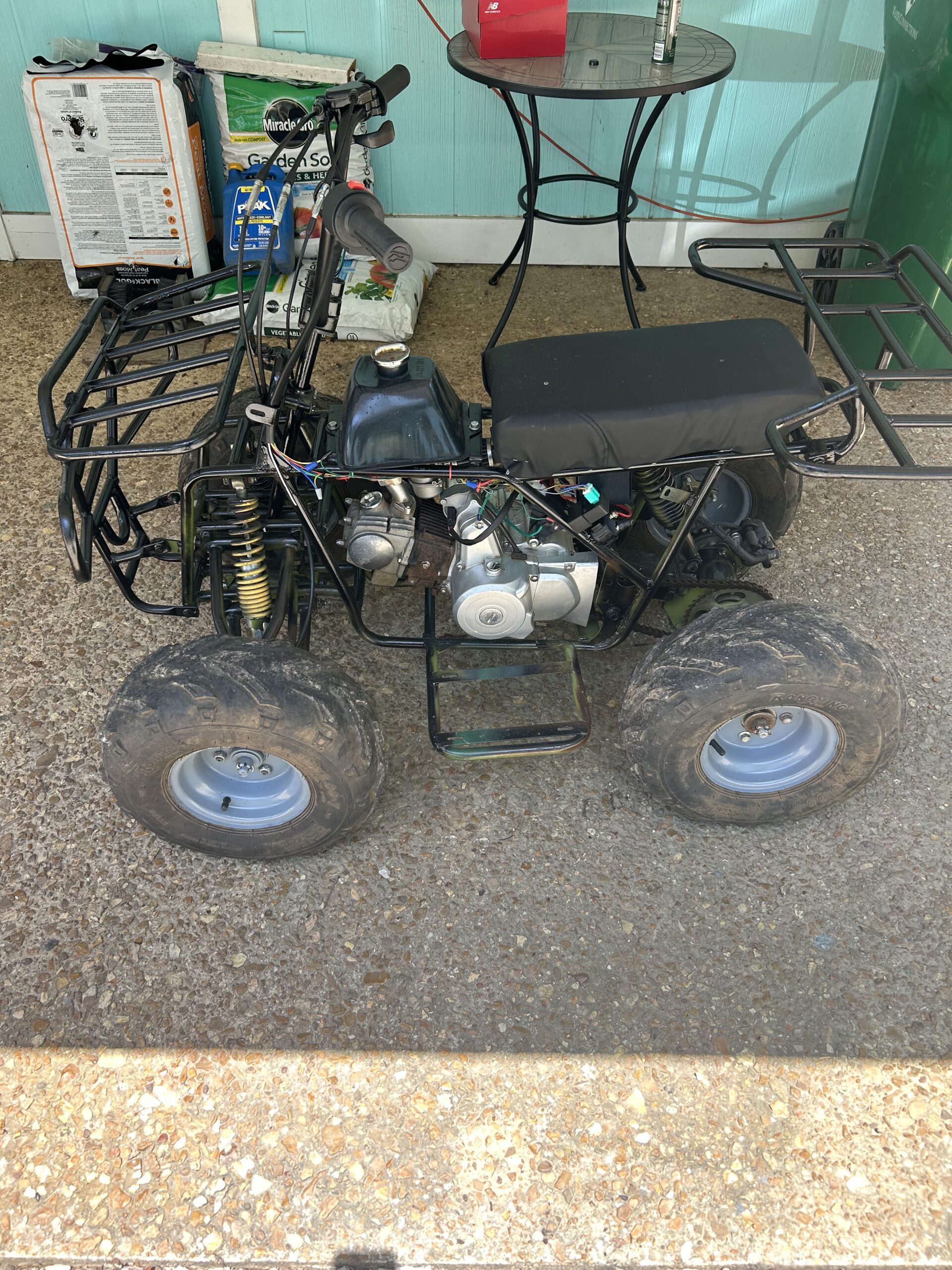 Four-wheeler parked on gravel surface.