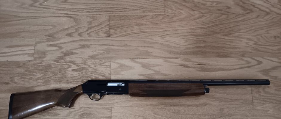 Wooden shotgun on wooden floor.